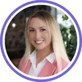 A headshot of a smiling blonde woman wearing a hot pink blazer with a purple ring around the image.